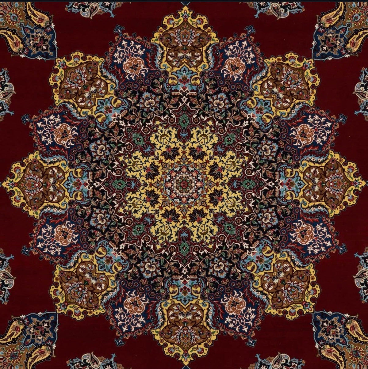 Close-up of a patterned rug with intricate designs on a red background