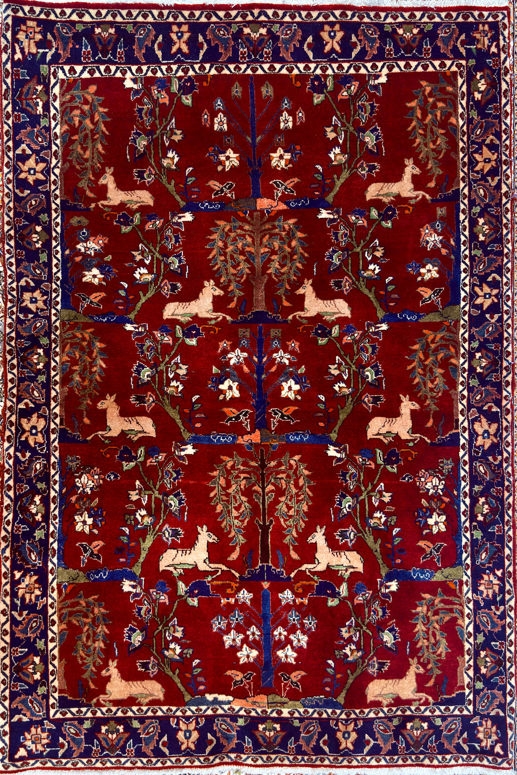 Antique Bakhtiari Zaronim carpet with intricate animal and floral designs on a red background
