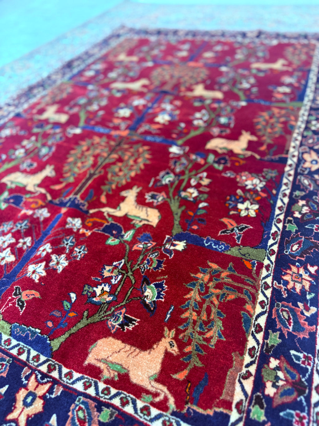Close-up of a colorful rug with intricate patterns and animal designs.