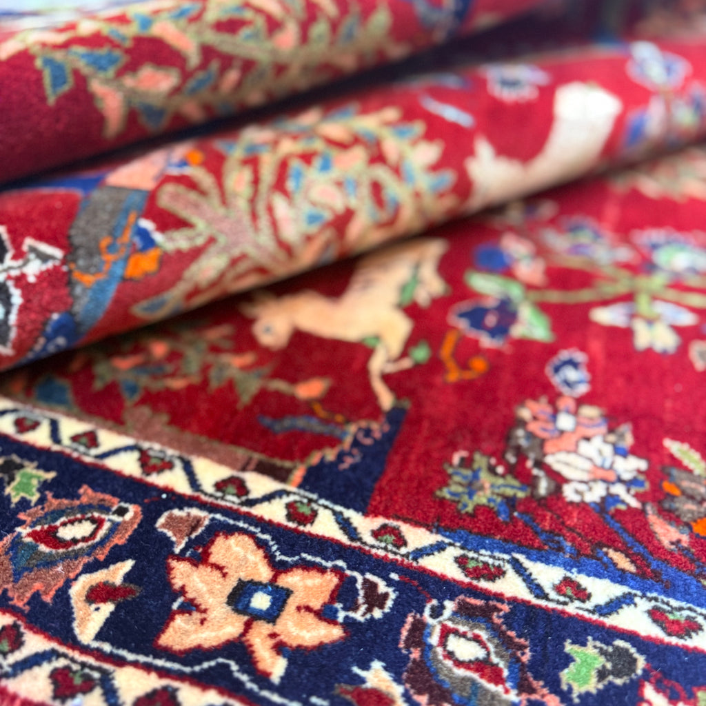 Antique Bakhtiari Zaronim carpet with intricate animal and floral designs on a red background