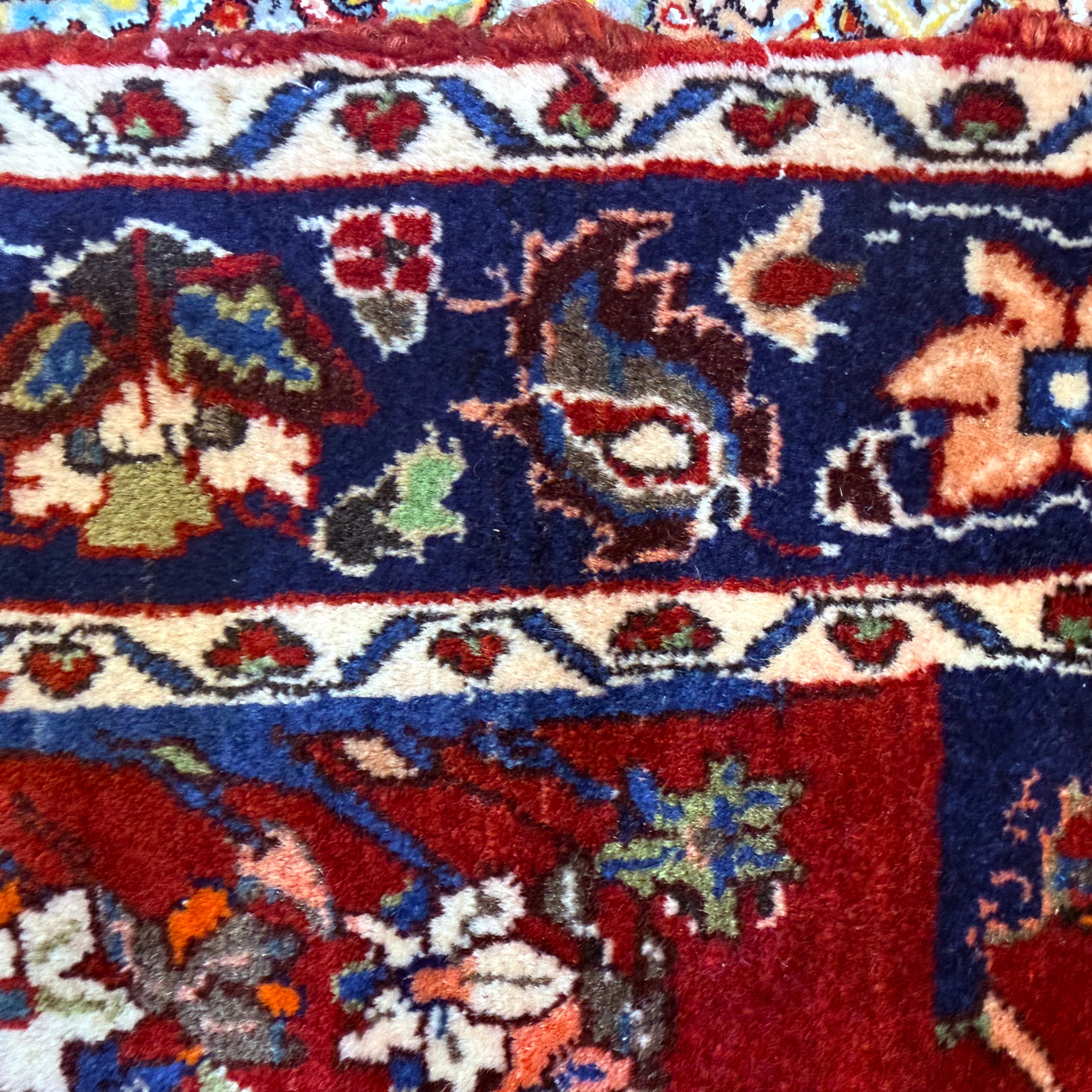 Antique Bakhtiari Zaronim carpet with intricate animal and floral designs on a red background and blue borders and white sub-border