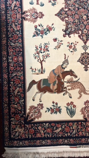 A traditional oriental rug with a cream background, featuring a central scene of a rider on a horse and a leopard, surrounded by floral motifs and a dark navy blue patterned border.