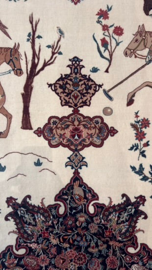 A close-up of an ornate patterned rug or textile with a cream background, featuring a large dark navy and burgundy central medallion, smaller matching motifs, and western-style horse illustrations in brown, red, and blue.