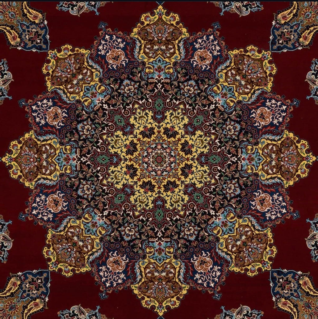 Close-up of a patterned rug with intricate designs on a red background