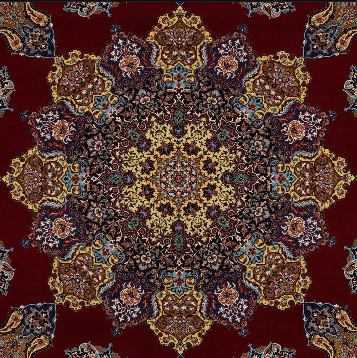 Close-up of a patterned rug with intricate designs on a red background