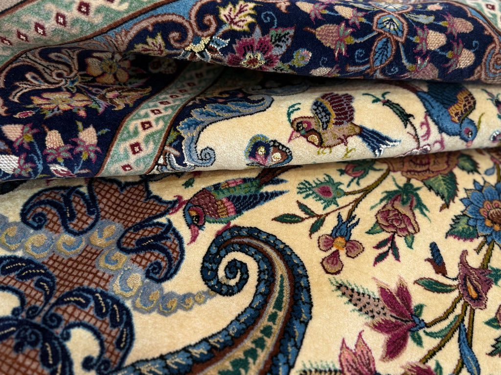 Close-up of intricately patterned fabric with floral and paisley designs.