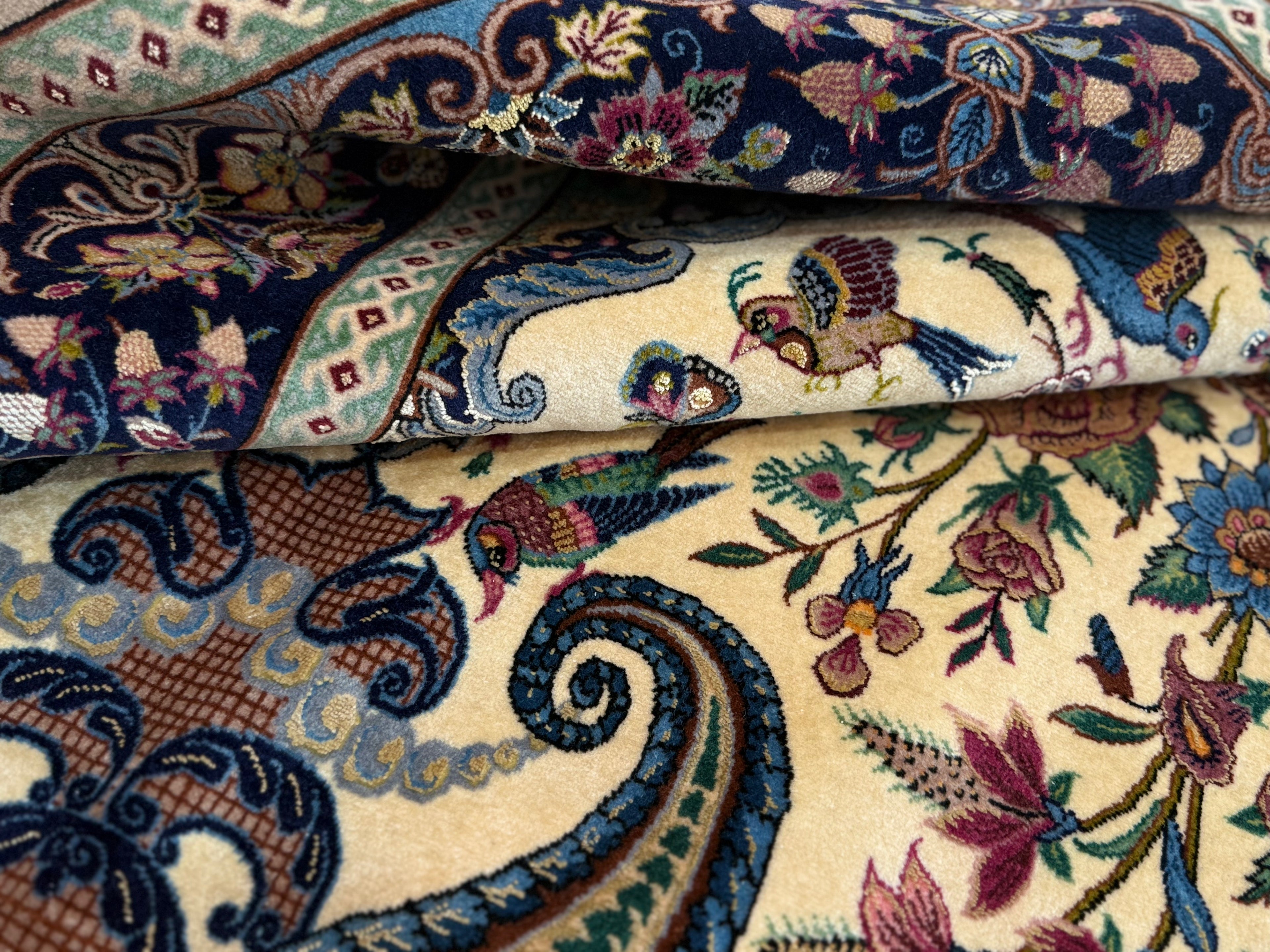 Close-up of intricately patterned fabric with floral and paisley designs.