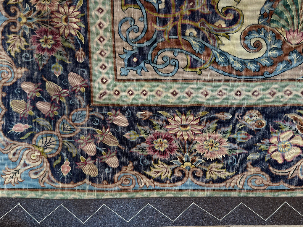 Close-up of a detailed floral and geometric patterned rug.