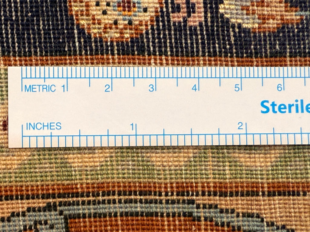 Close-up of a textured fabric with a ruler overlay for measurement, featuring the word 'Sterile'.