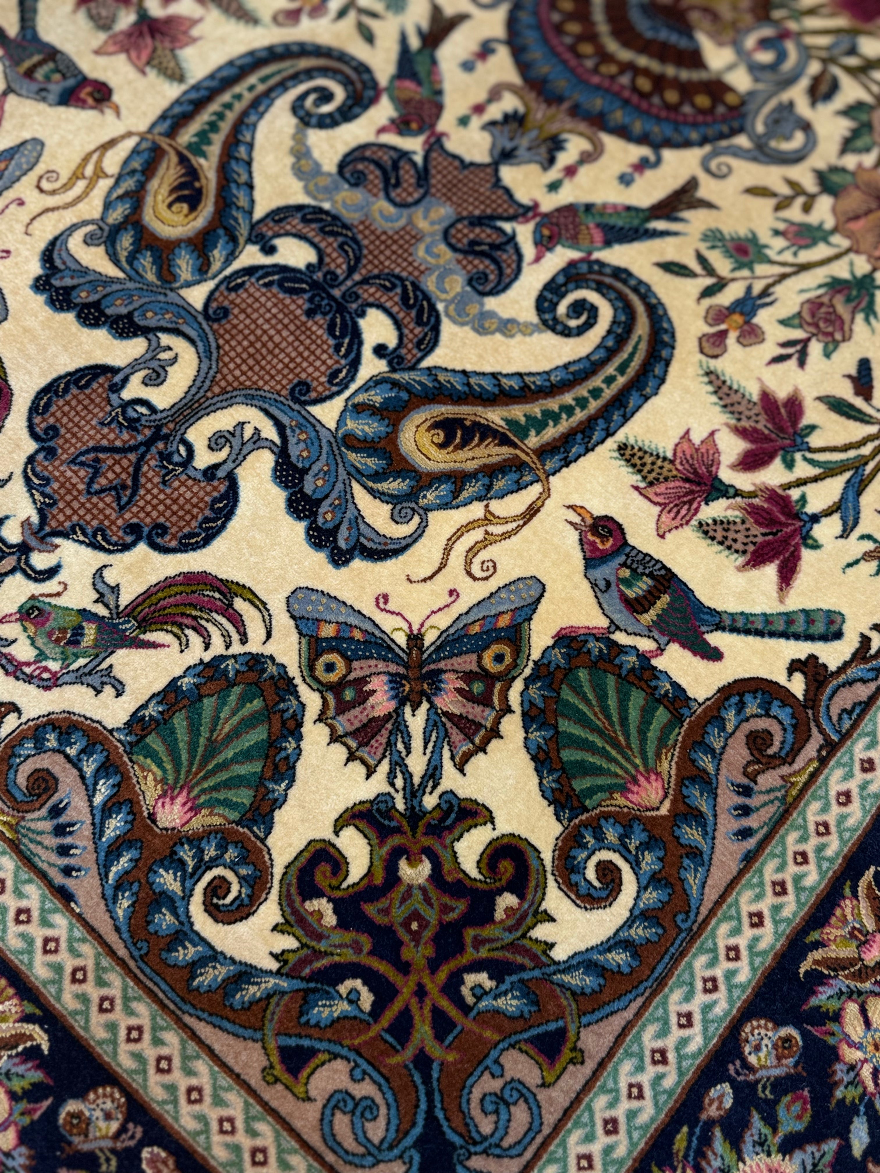 Close-up of a patterned fabric with intricate designs including butterflies and birds.