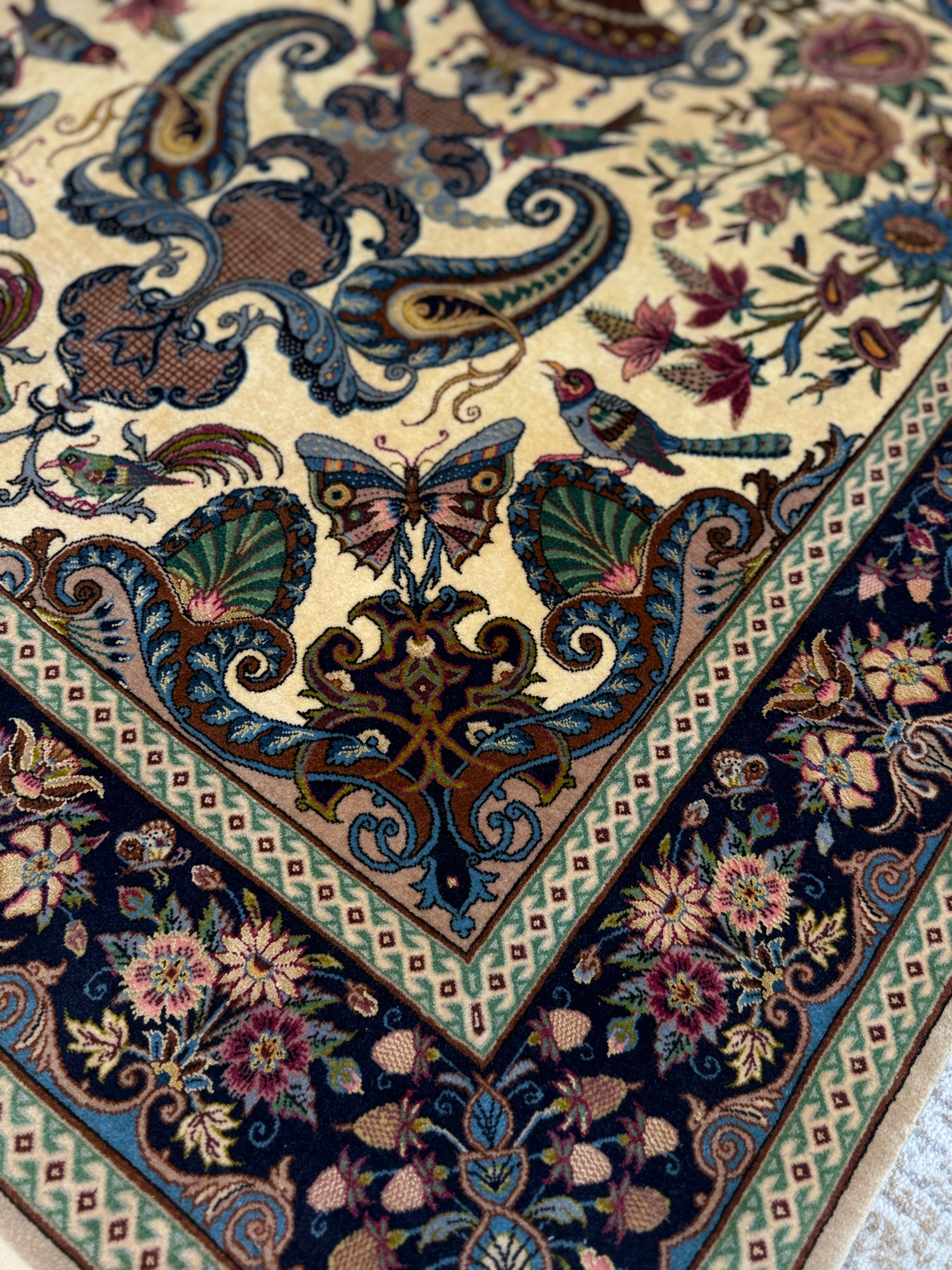 Close-up of a intricately designed rug with floral and butterfly patterns.