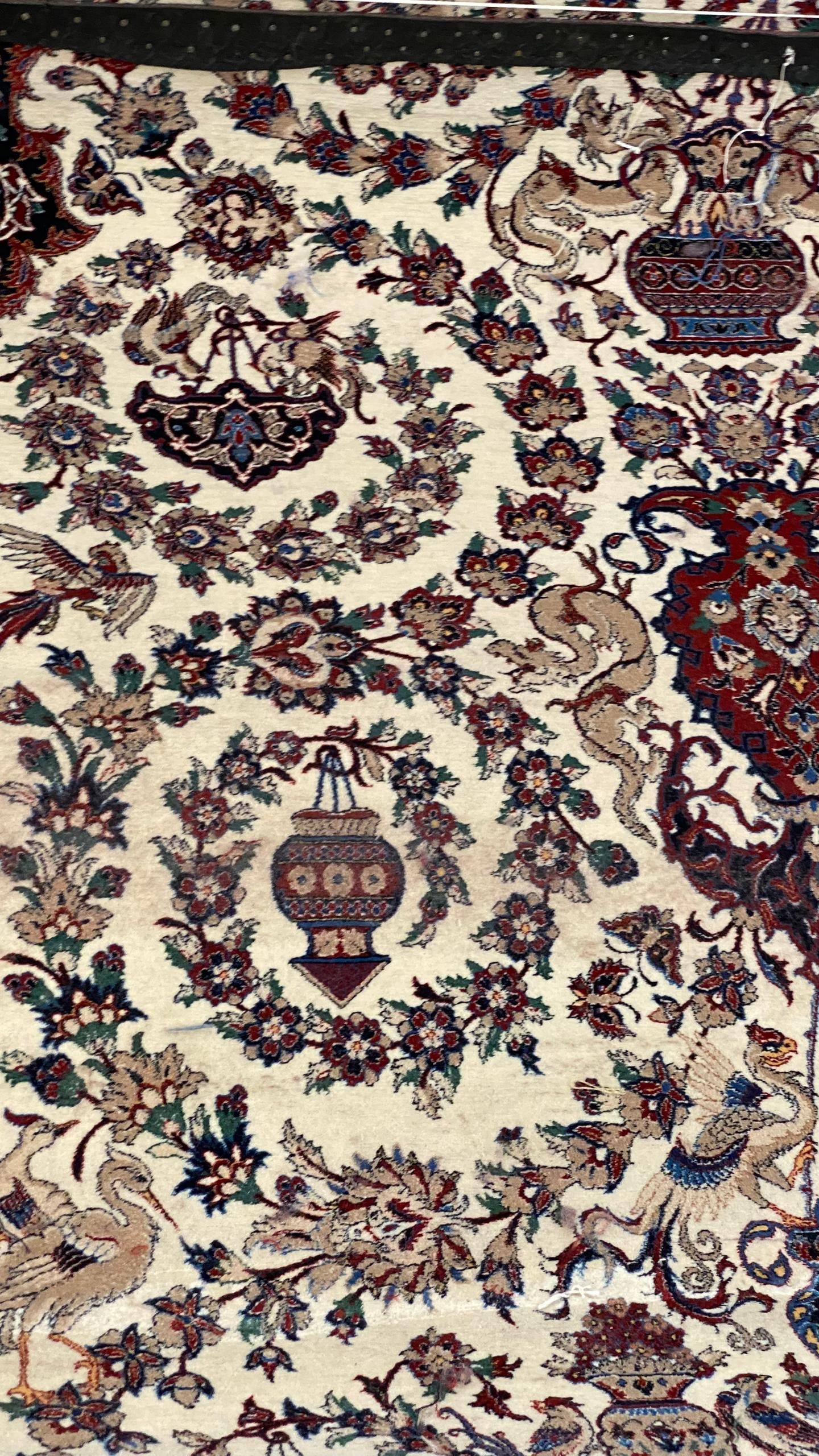Decorative rug with intricate patterns and colors on a beige background