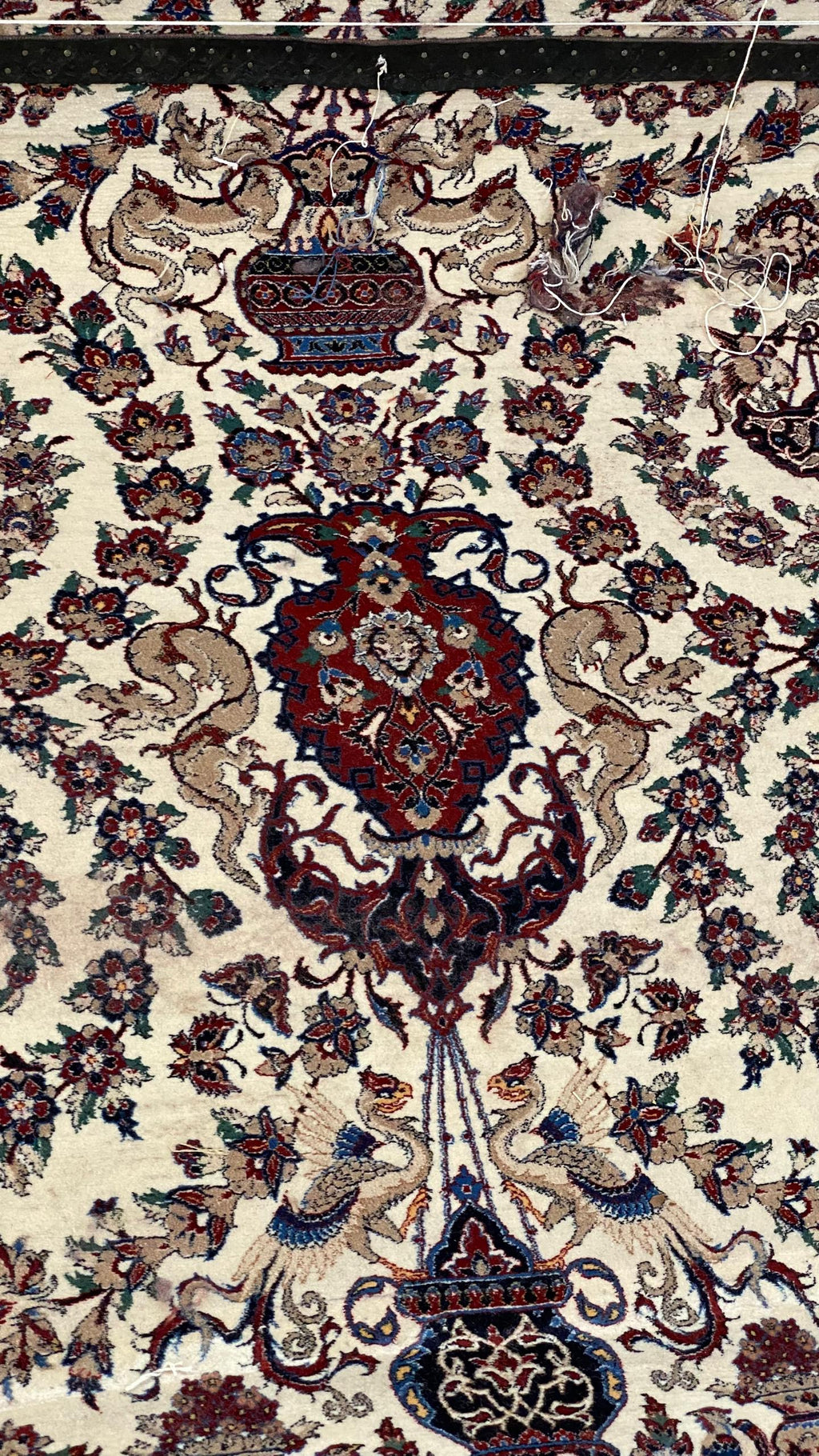 Close-up of a patterned rug with intricate designs and colors.