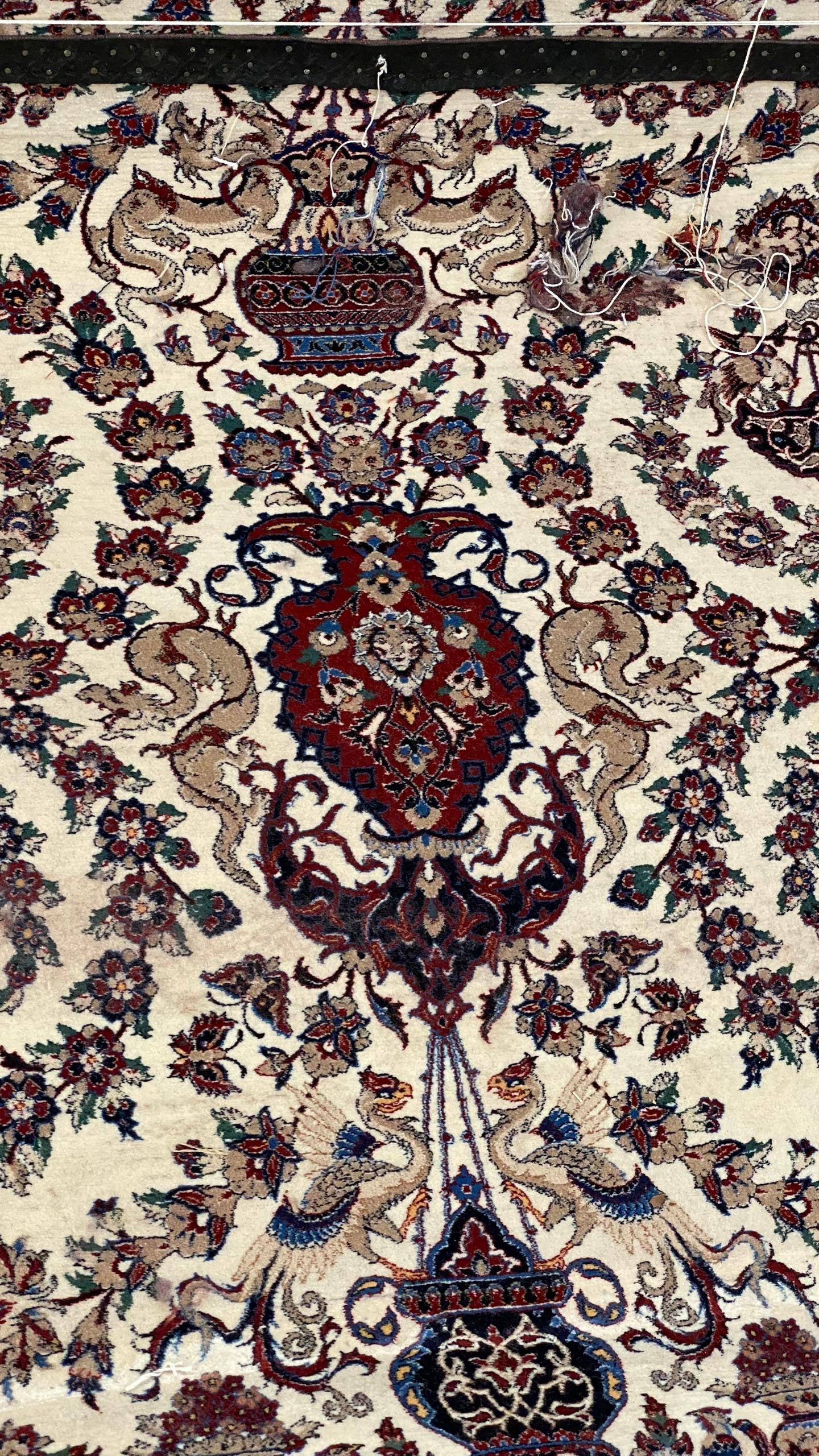 Close-up of a patterned rug with intricate designs and colors.