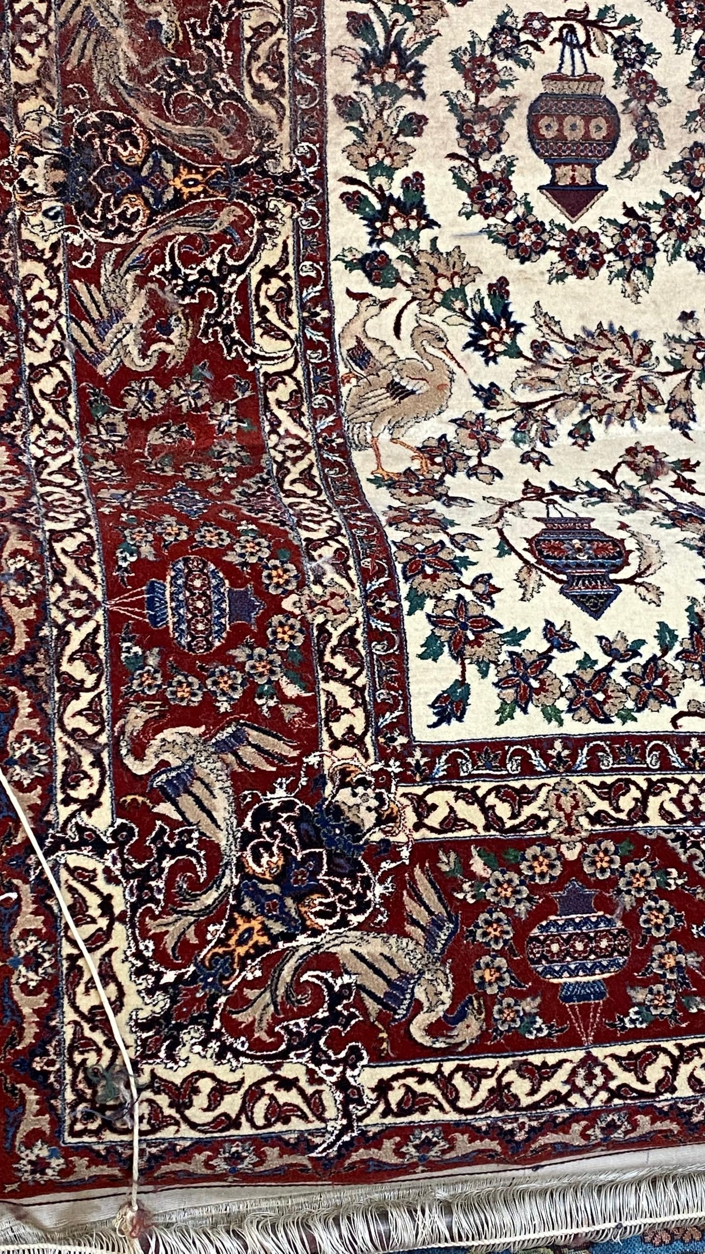 Close-up of a patterned rug with intricate designs and colors.