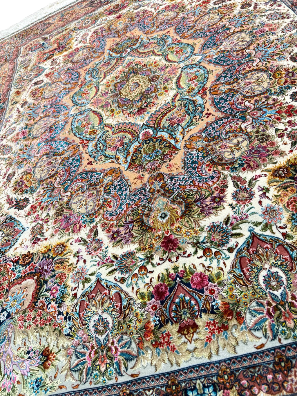 Close-up of a colorful floral patterned rug with intricate details.