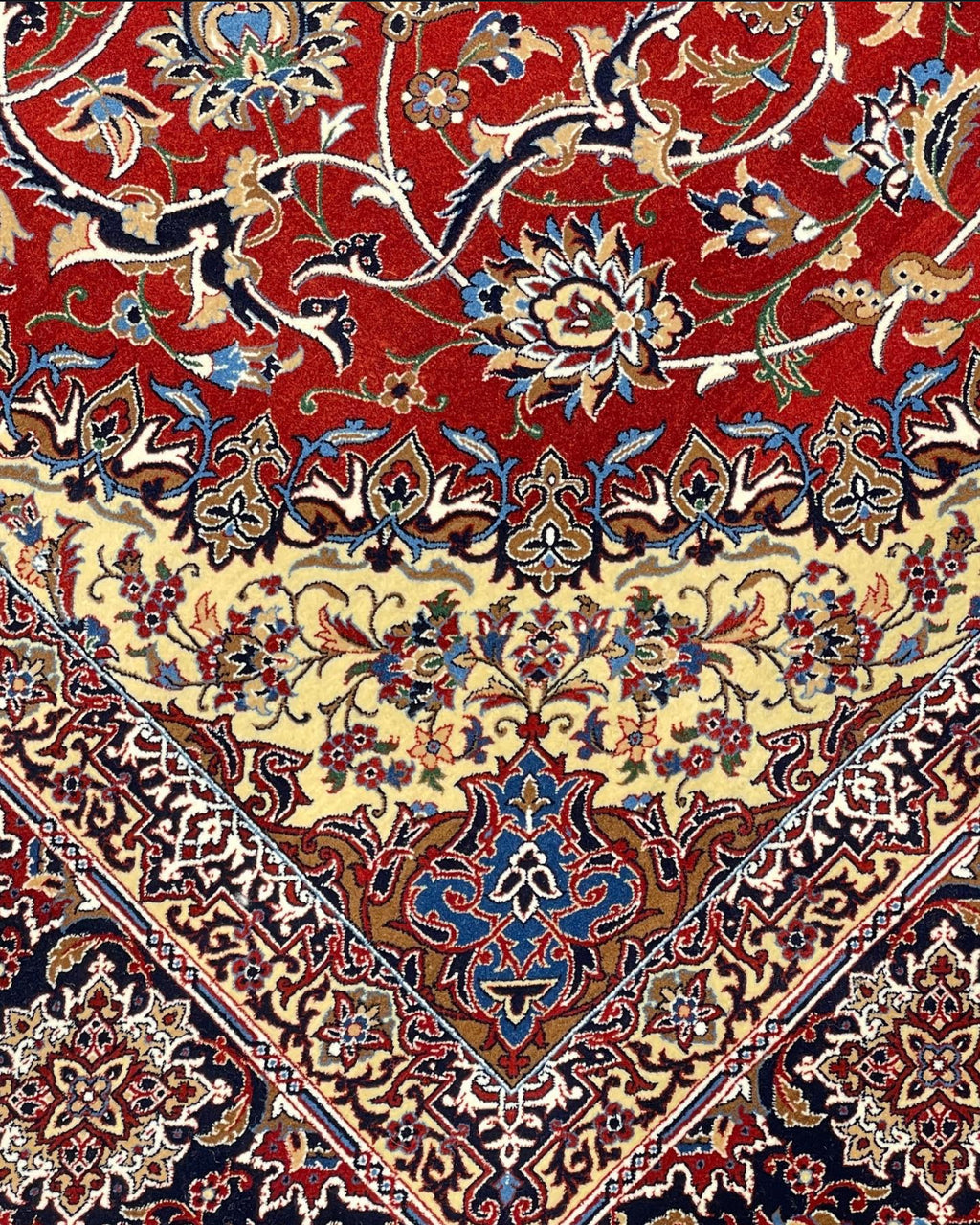 Close-up of a patterned rug with intricate designs on a red background