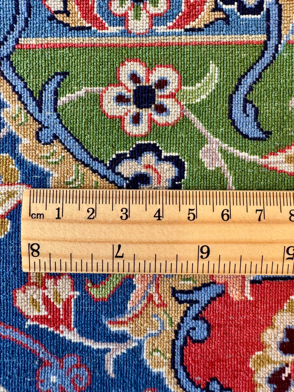 Close-up of a patterned fabric with a ruler for scale