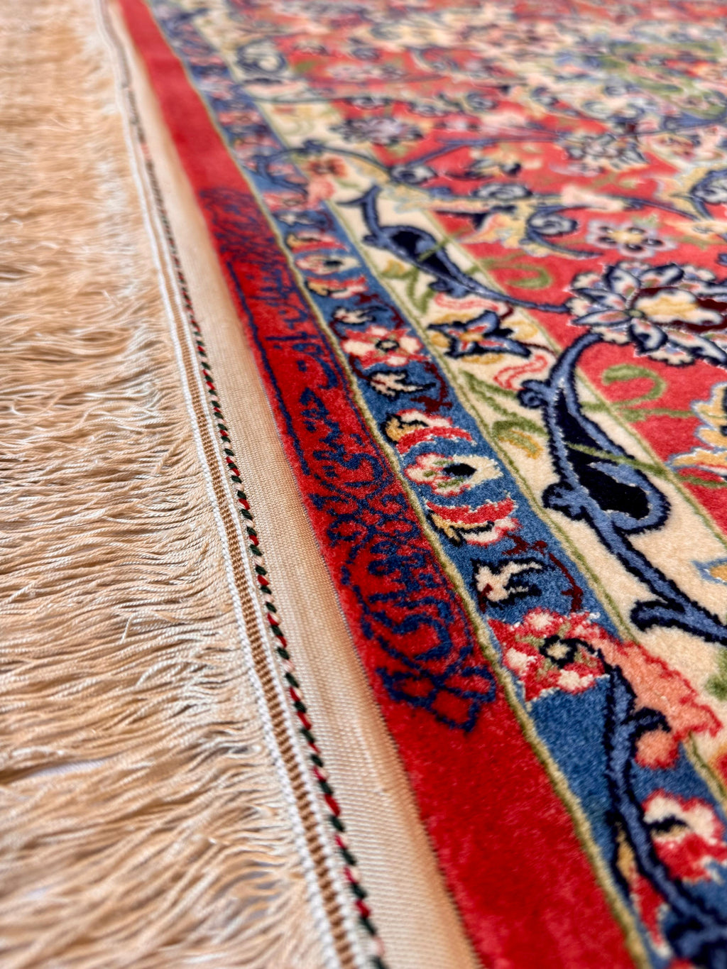 Close-up of a colorful patterned rug with fringes