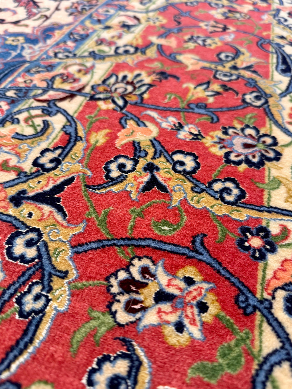 Close-up of a colorful floral patterned rug with red background
