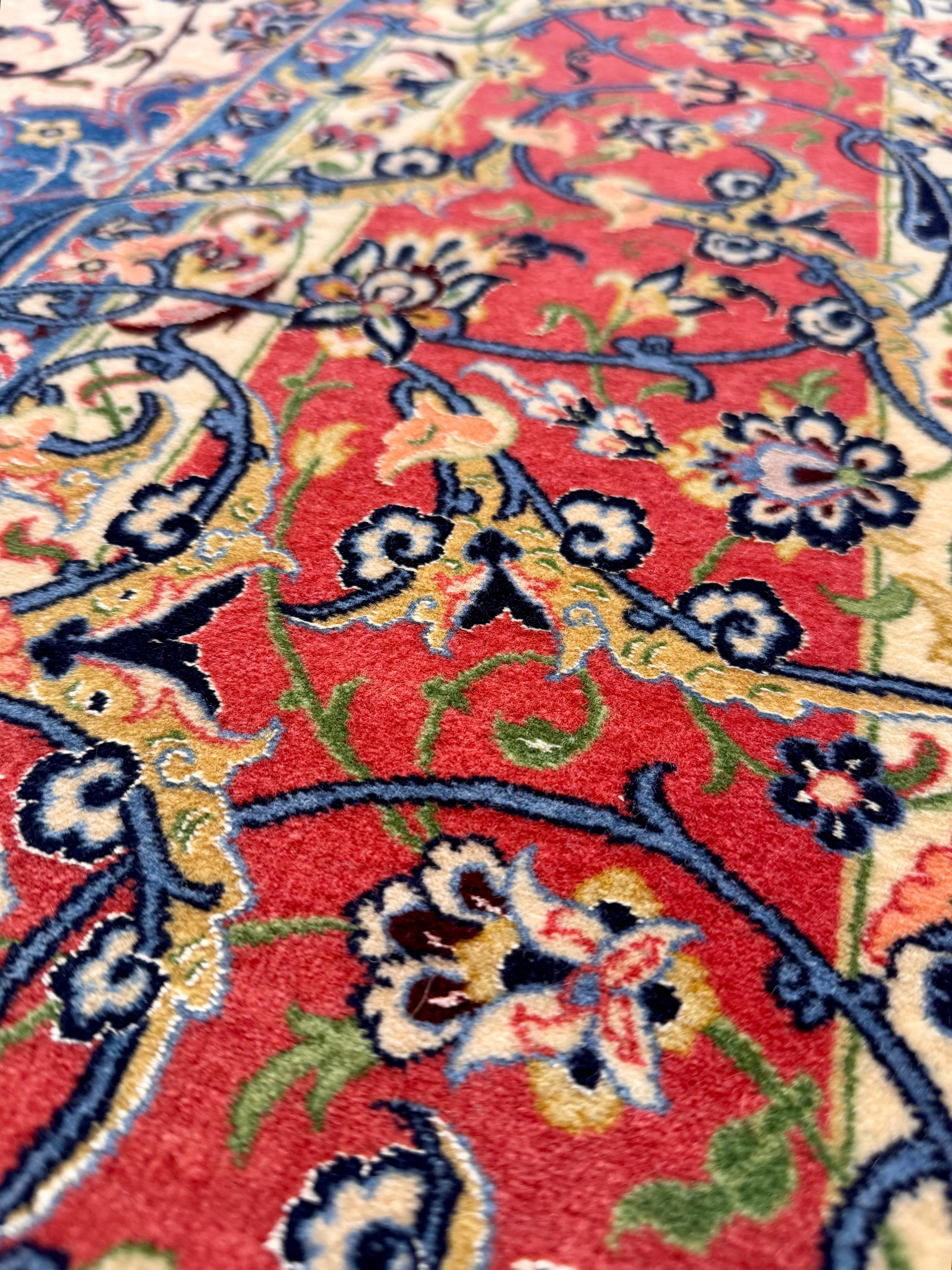 Close-up of a colorful floral patterned rug with red background