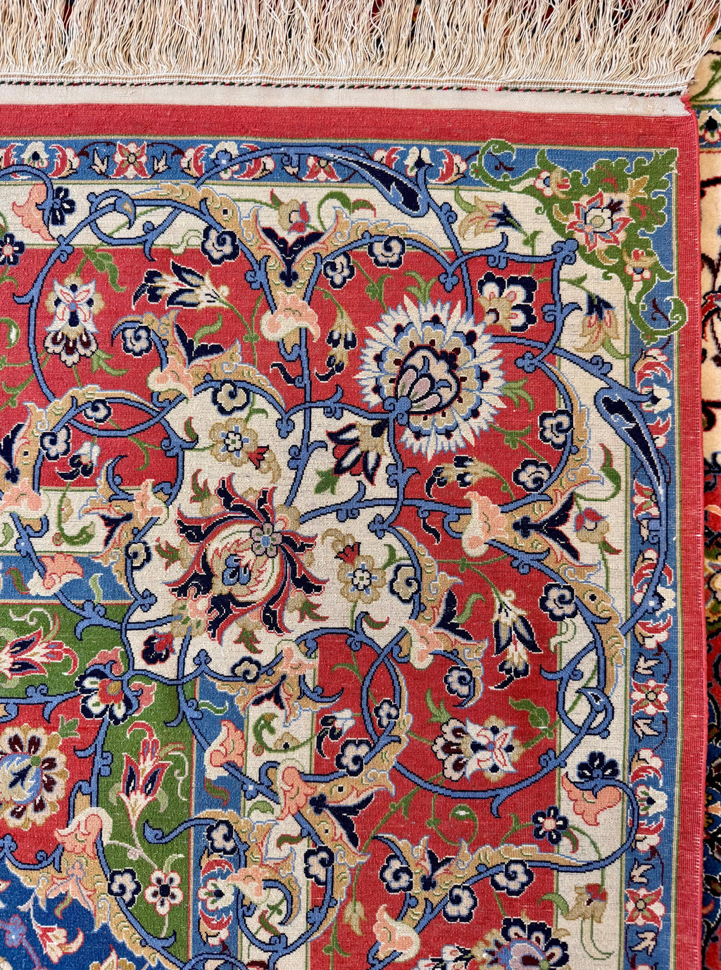Close-up of a colorful floral patterned rug with intricate designs.