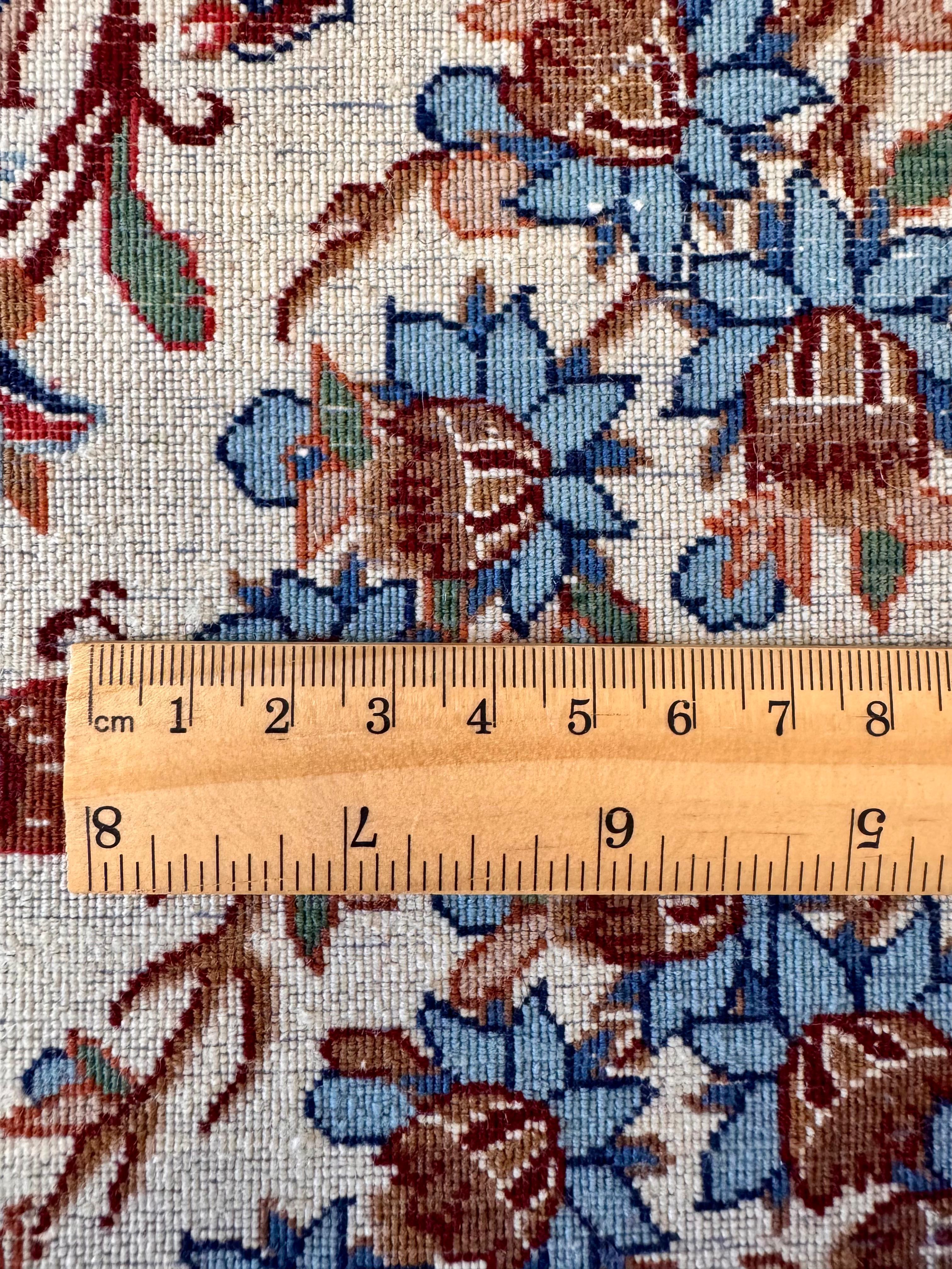 Floral patterned fabric with a wooden ruler for scale