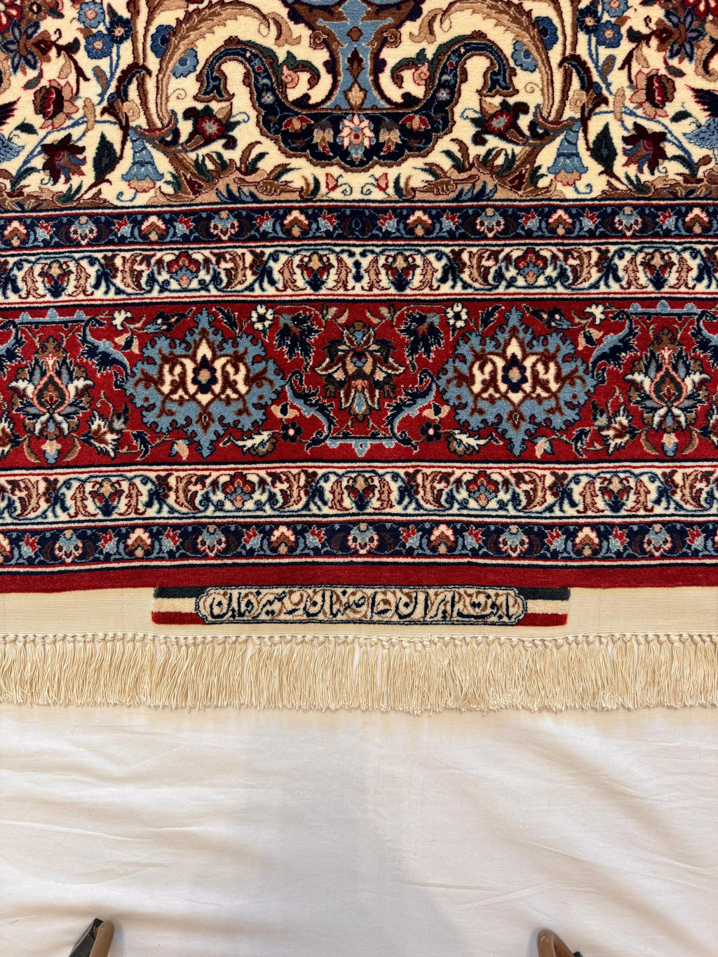 Close-up of a patterned rug with intricate designs on a white background