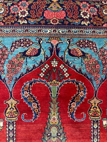 Decorative rug with intricate patterns, peacocks, and floral designs.