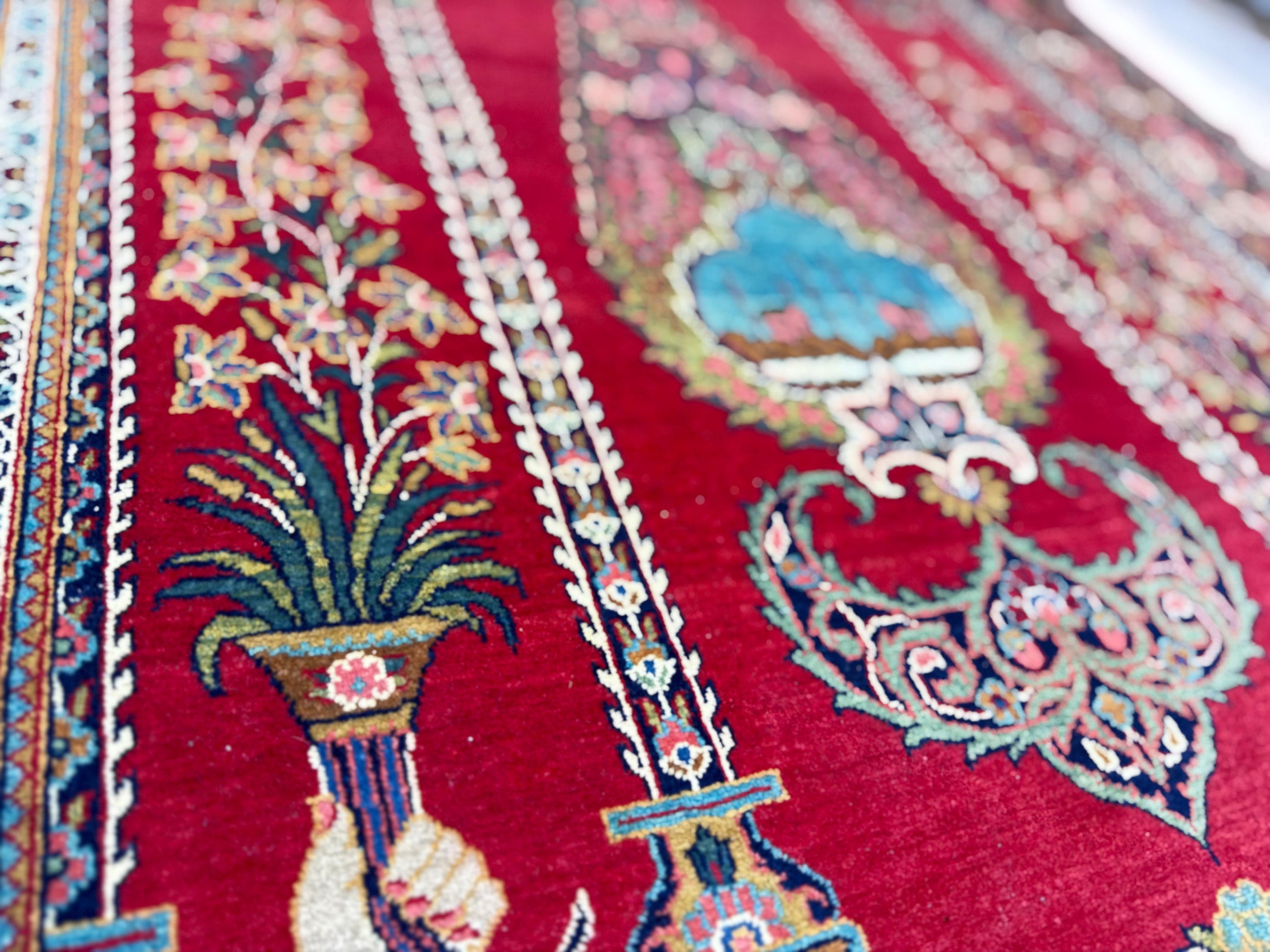 Close-up of a red patterned rug with intricate designs