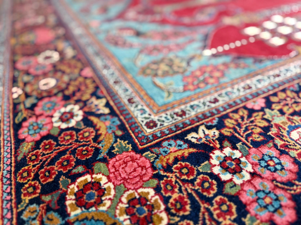 Close-up of a colorful floral-patterned rug with intricate designs.