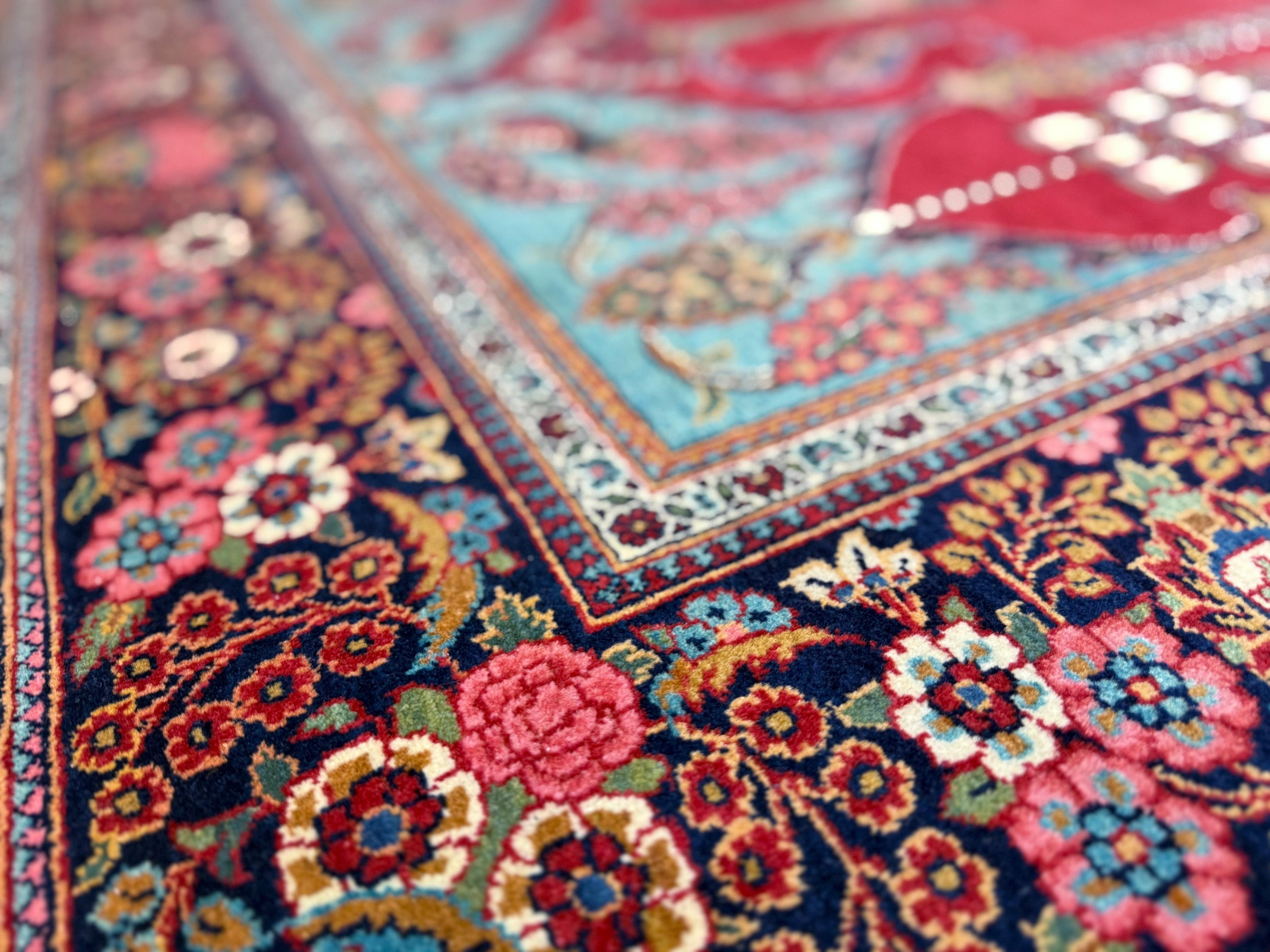 Close-up of a colorful floral-patterned rug with intricate designs.