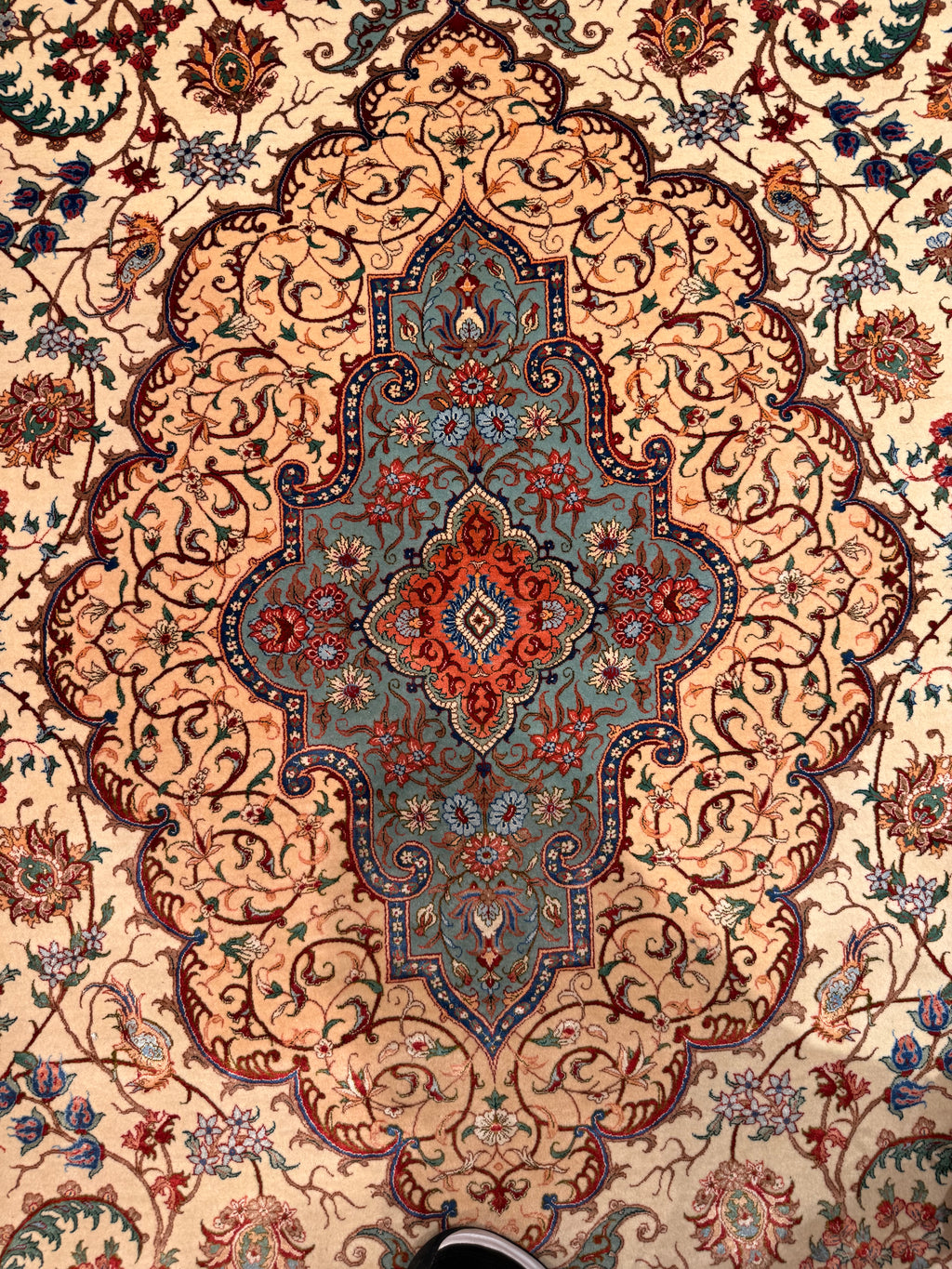 Close-up of an intricately designed rug with a central medallion.