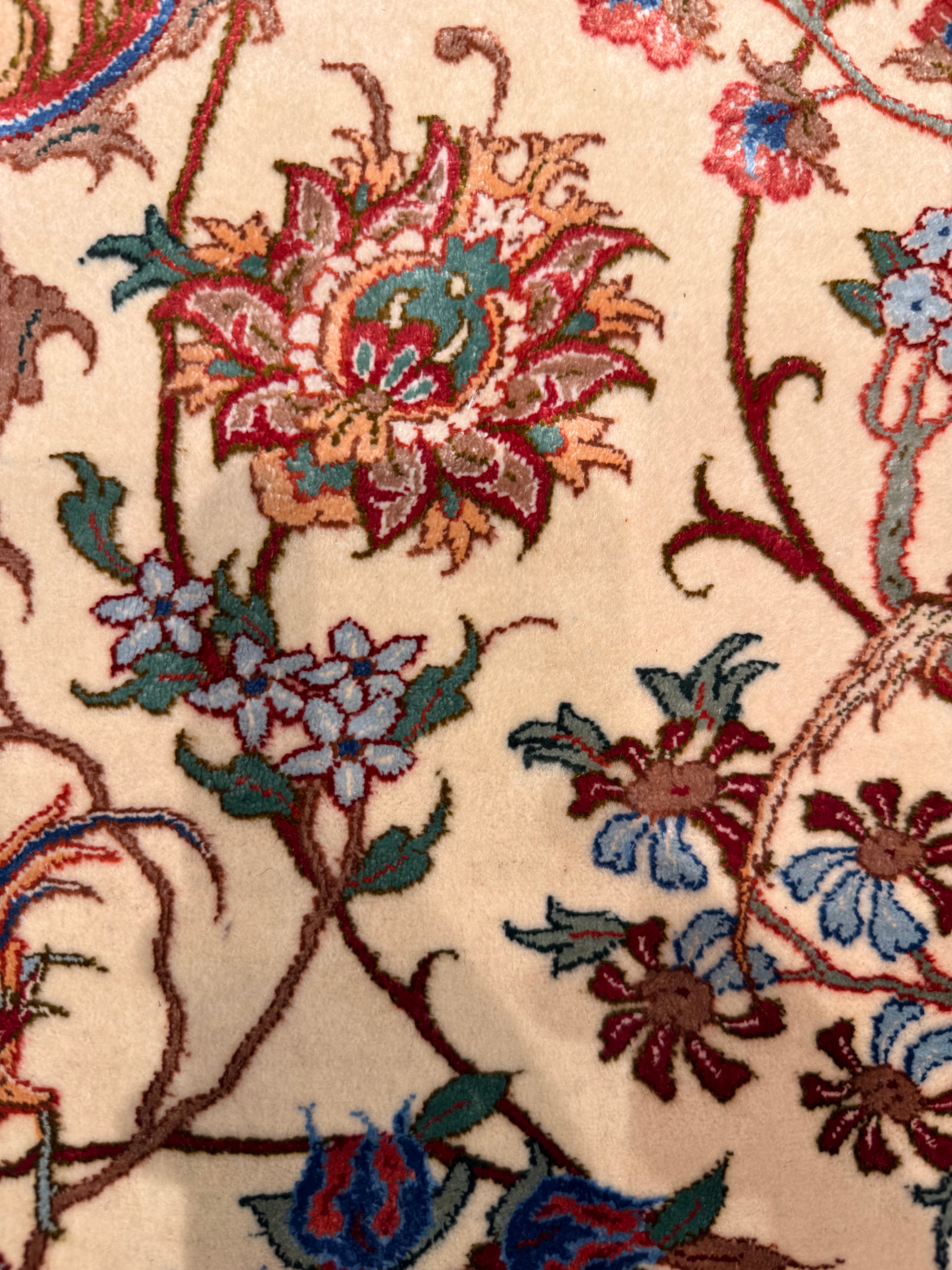 Close-up of a floral patterned rug with intricate details.