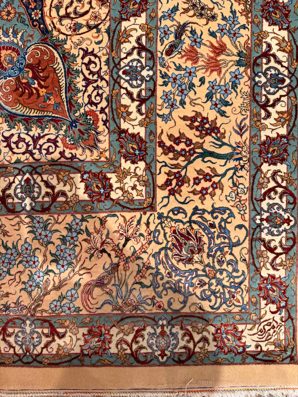 Close-up of an intricately designed rug with floral patterns.