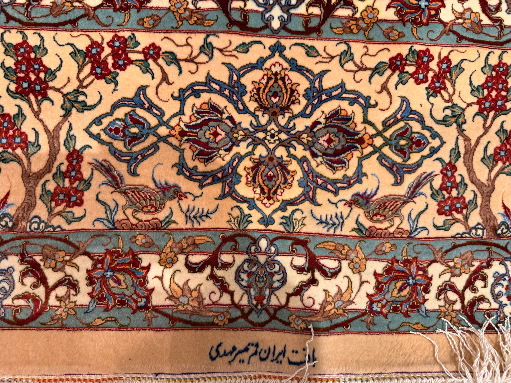 Close-up of a intricately designed rug with floral and animal patterns.