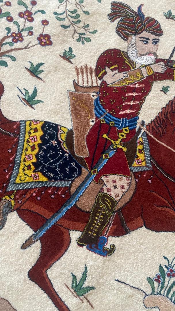 Equestrian scene with a warrior on horseback, holding a spear, from a tapestry or embroidery.