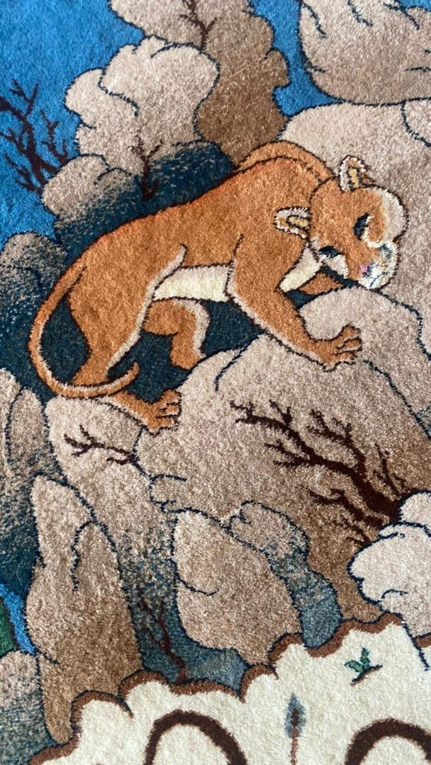 Carpet with a design of a mountain lion on a rocky landscape