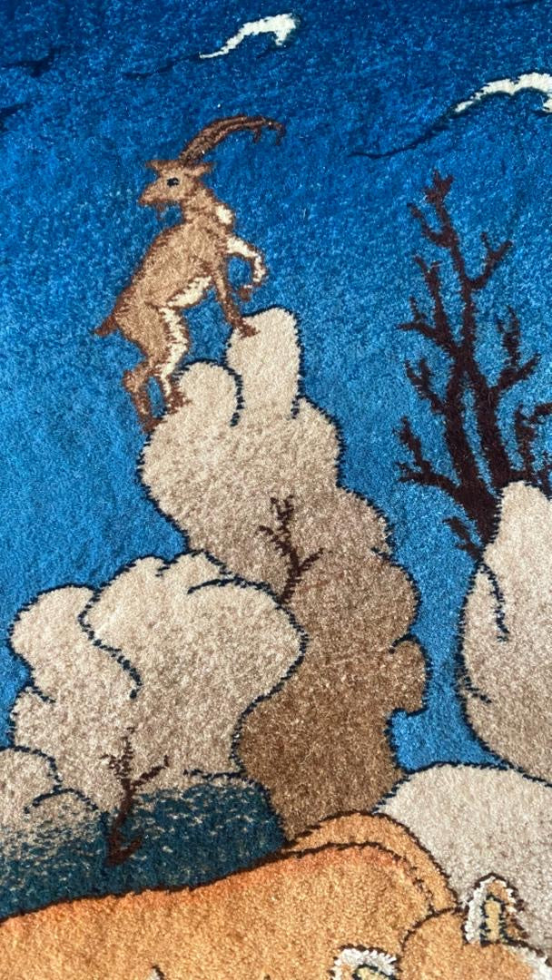 Rug with a goat design on a blue background