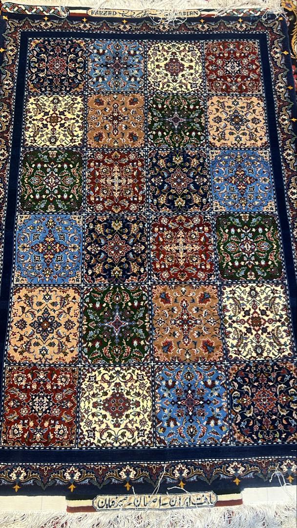 Decorative rug with a patchwork design featuring various colors and patterns.