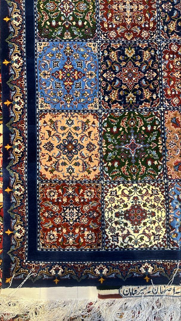 Decorative rug with intricate patterns and colors on a dark background